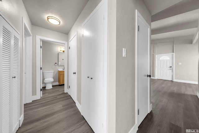 corridor with hardwood / wood-style flooring