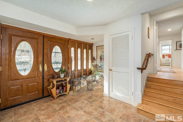 foyer entrance featuring french doors and a textured ceiling