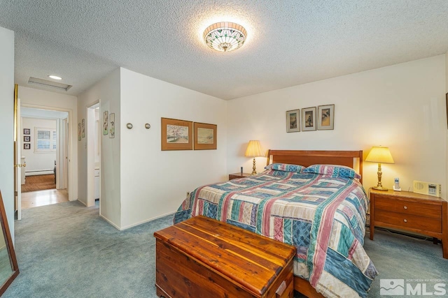 carpeted bedroom featuring a textured ceiling