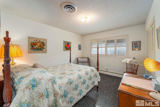 bedroom with baseboard heating, a textured ceiling, and a closet