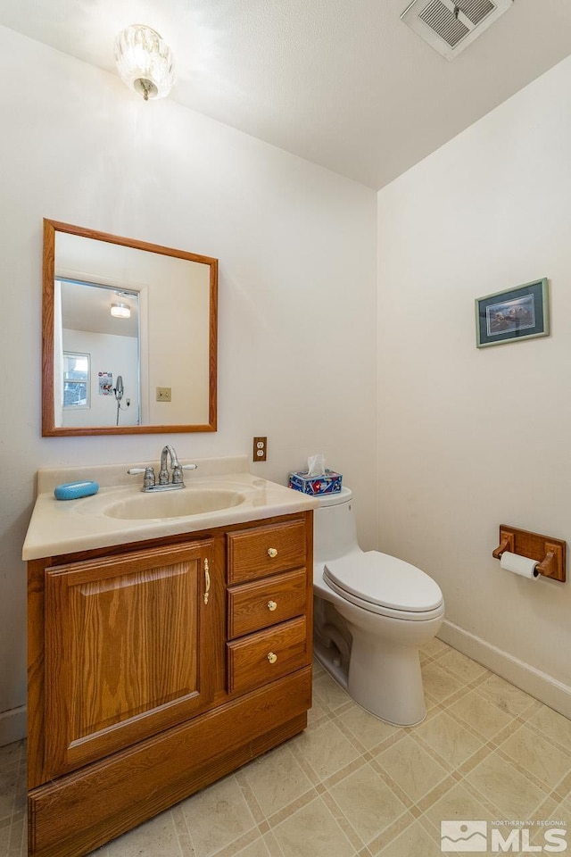 bathroom featuring toilet and vanity