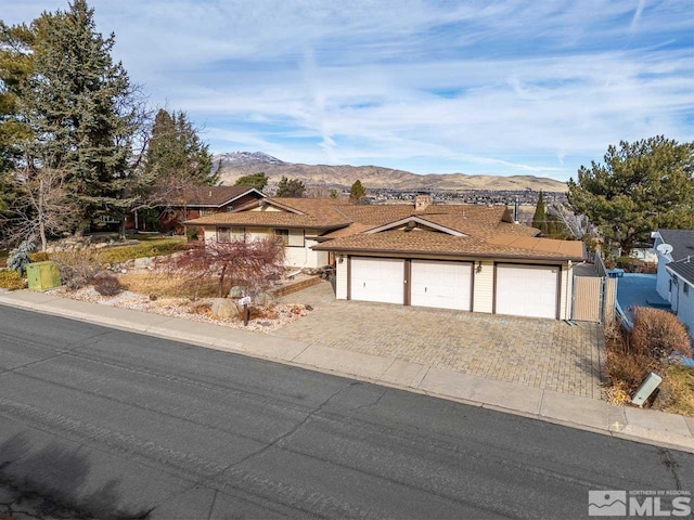 view of front of property with a garage and a mountain view