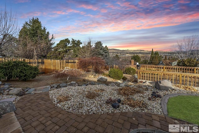 yard at dusk with a patio area