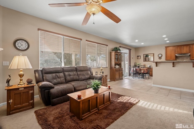 tiled living room with ceiling fan