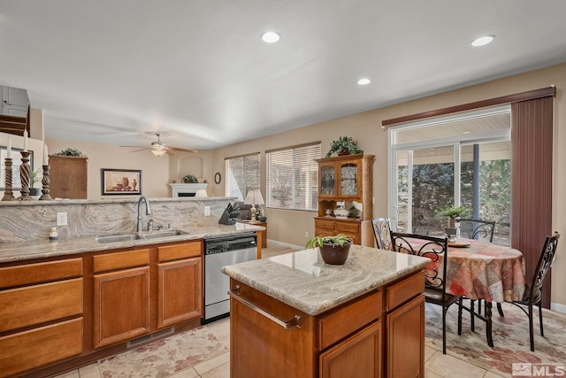 kitchen with stainless steel dishwasher, ceiling fan, sink, and plenty of natural light