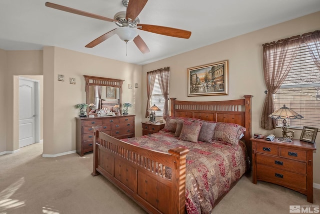 bedroom featuring light carpet and ceiling fan