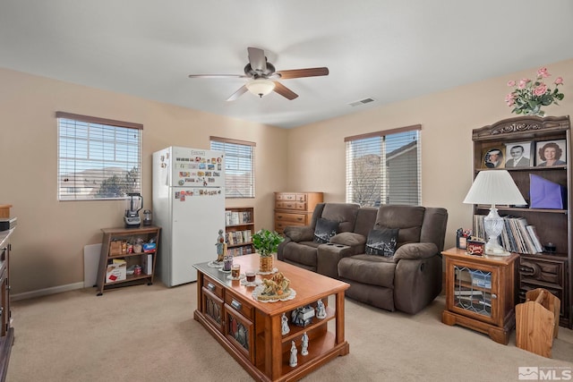 carpeted living room featuring ceiling fan