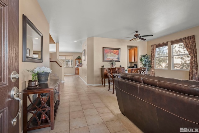 tiled living room with ceiling fan