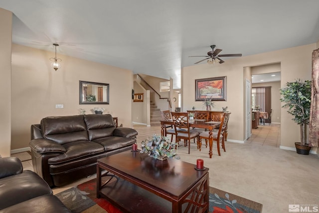 carpeted living room featuring ceiling fan