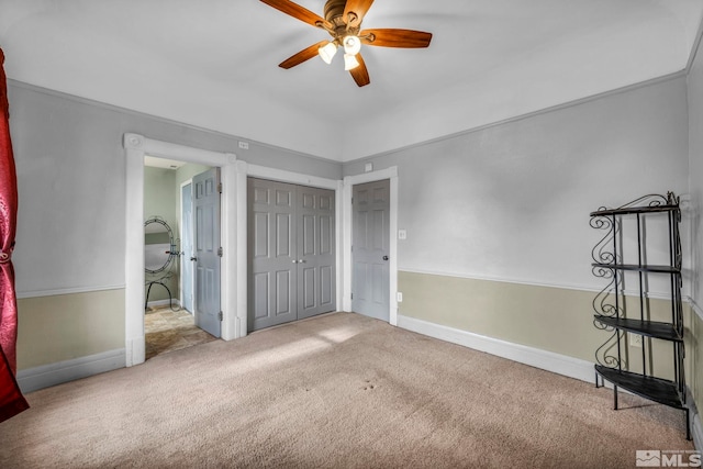 unfurnished bedroom with a closet, ceiling fan, and light carpet