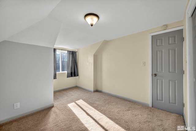 bonus room featuring light colored carpet and vaulted ceiling