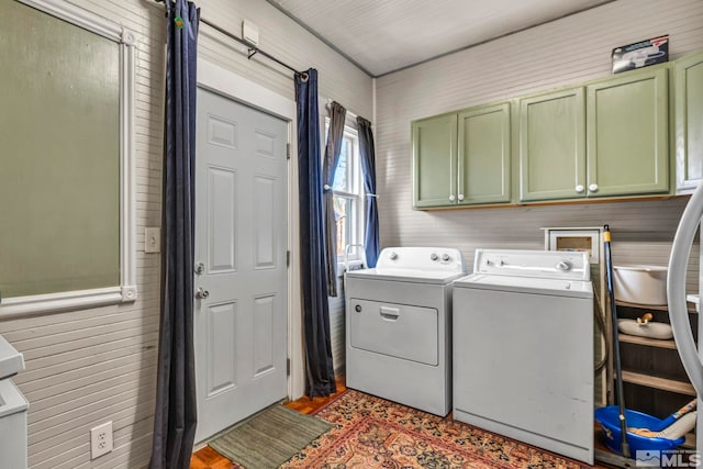 laundry room featuring cabinets and washing machine and clothes dryer