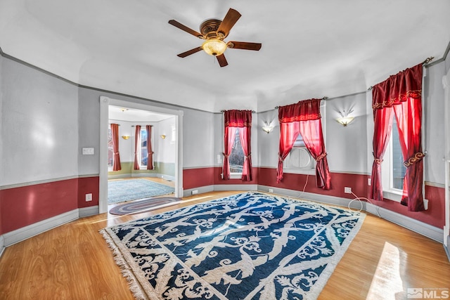 unfurnished room with ceiling fan and wood-type flooring