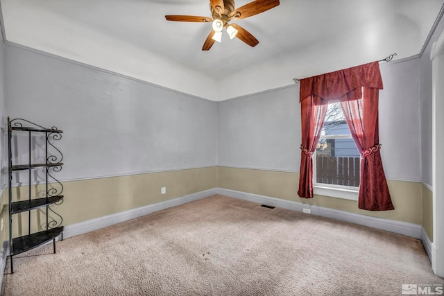 spare room featuring carpet floors and ceiling fan