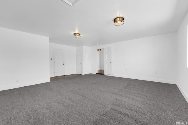 unfurnished room with dark carpet