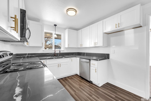 kitchen with hanging light fixtures, stainless steel appliances, dark hardwood / wood-style flooring, white cabinets, and sink