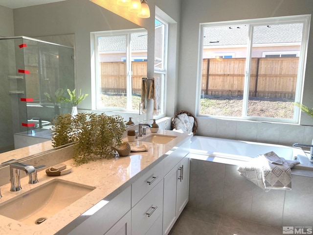 bathroom featuring vanity, tile patterned flooring, and plus walk in shower