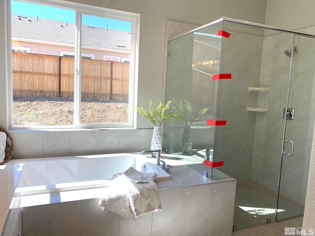 bathroom with separate shower and tub