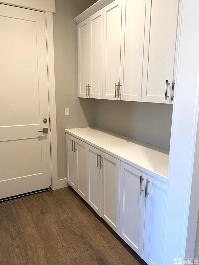 clothes washing area with dark hardwood / wood-style floors