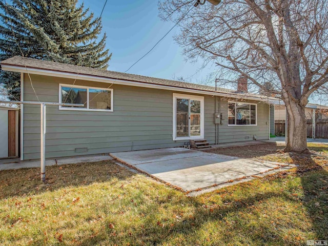 rear view of property featuring a lawn and a patio