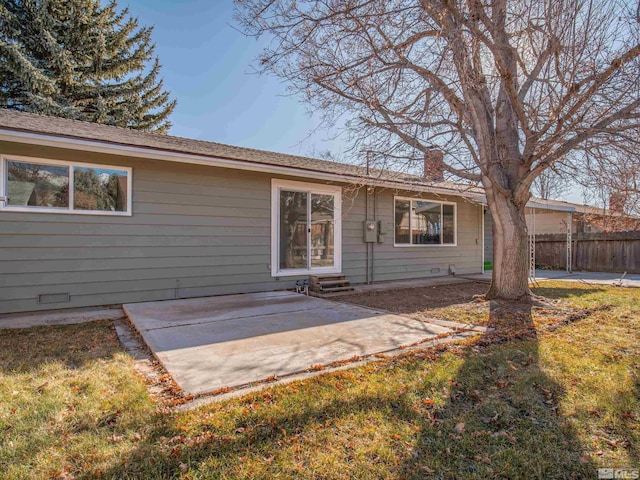 back of property with a patio and a lawn