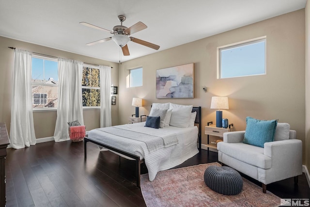 bedroom with ceiling fan and dark hardwood / wood-style flooring