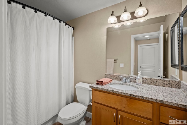 bathroom featuring toilet and vanity