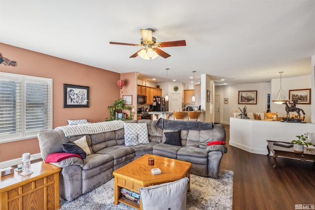 living room with ceiling fan and wood-type flooring