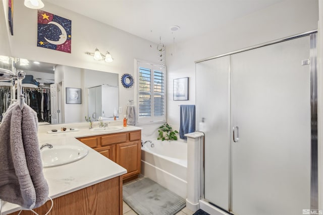 bathroom featuring vanity, tile patterned flooring, and separate shower and tub