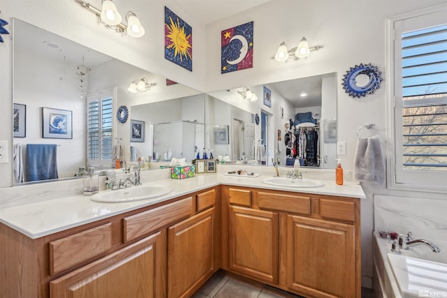 bathroom featuring vanity, tile patterned floors, a wealth of natural light, and separate shower and tub