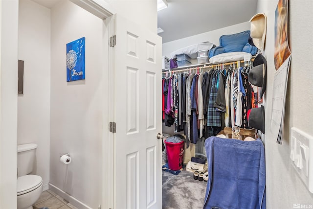 spacious closet with light tile patterned floors