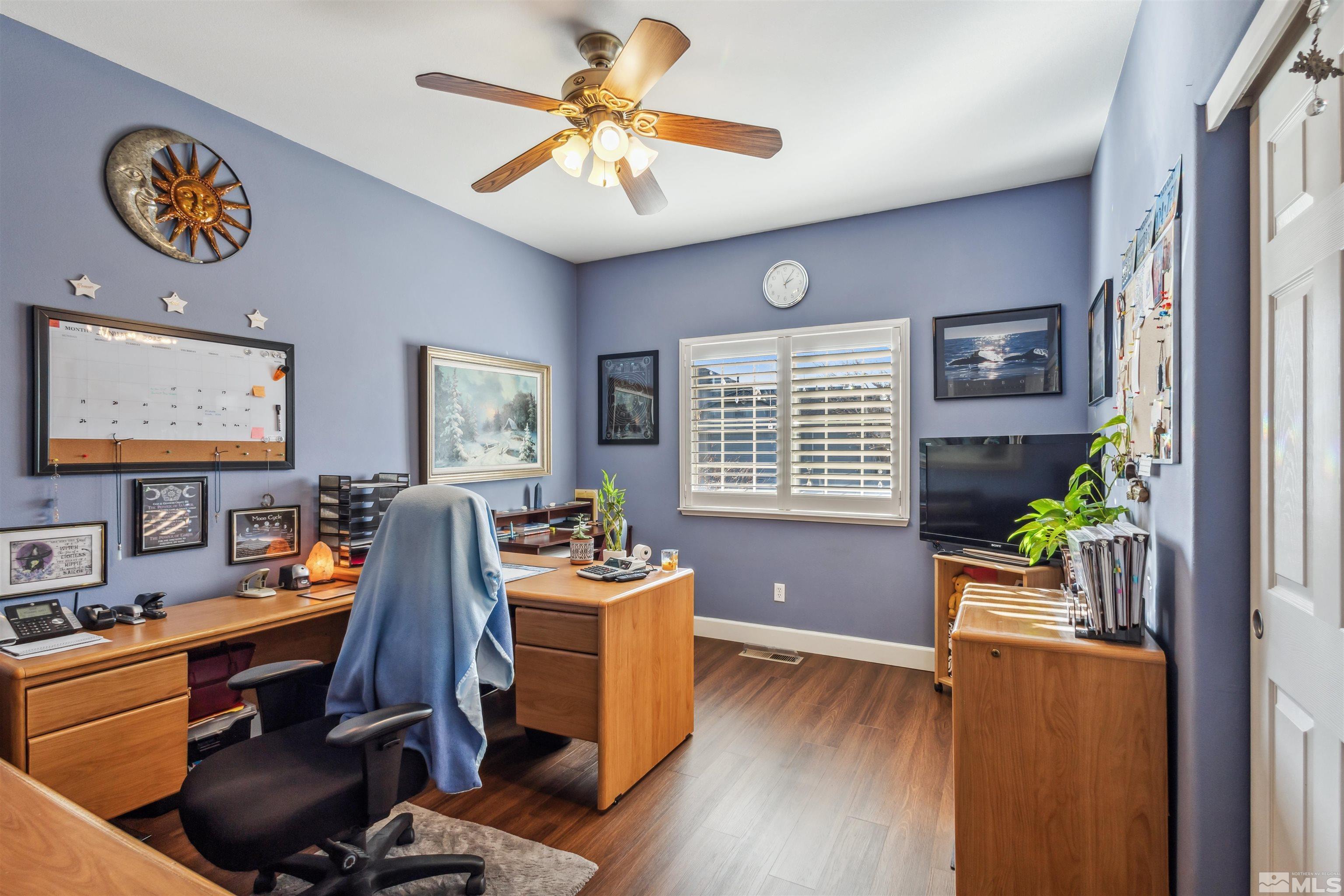 office space with ceiling fan and dark wood-type flooring