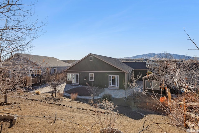 rear view of property with a patio and a mountain view