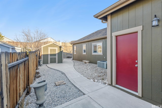 exterior space with cooling unit and a storage shed