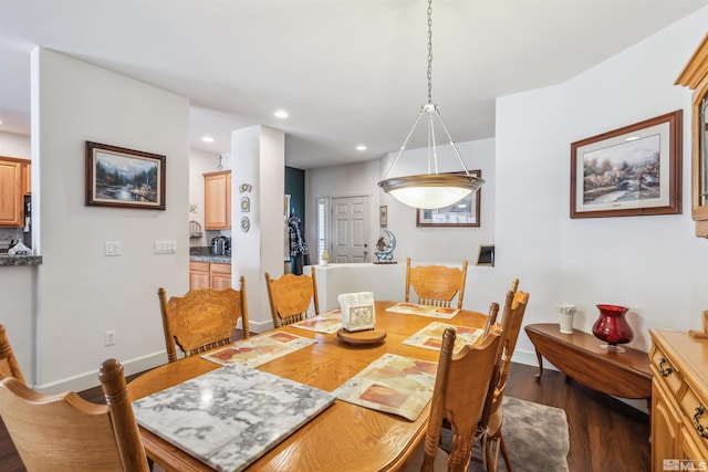 dining room with dark hardwood / wood-style flooring