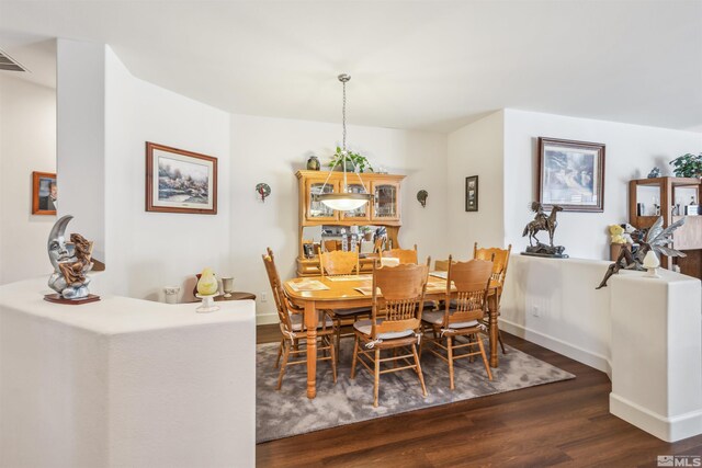 dining area with dark hardwood / wood-style floors