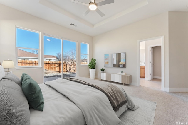 bedroom with access to outside, a raised ceiling, radiator, light colored carpet, and ceiling fan