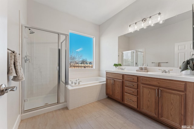 bathroom with vanity, hardwood / wood-style flooring, and independent shower and bath