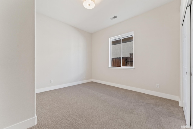 empty room featuring light carpet