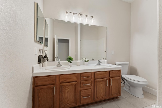 bathroom featuring toilet, tile patterned flooring, and vanity