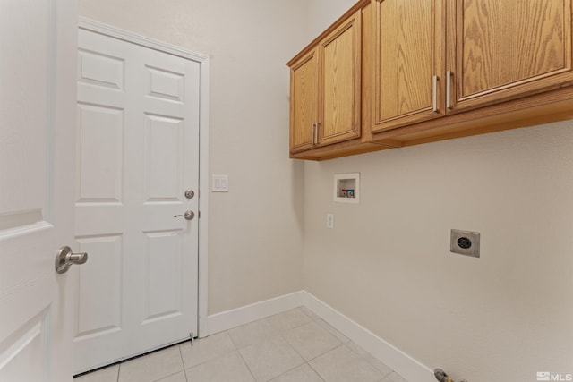 washroom with light tile patterned floors, hookup for a washing machine, cabinets, and hookup for an electric dryer