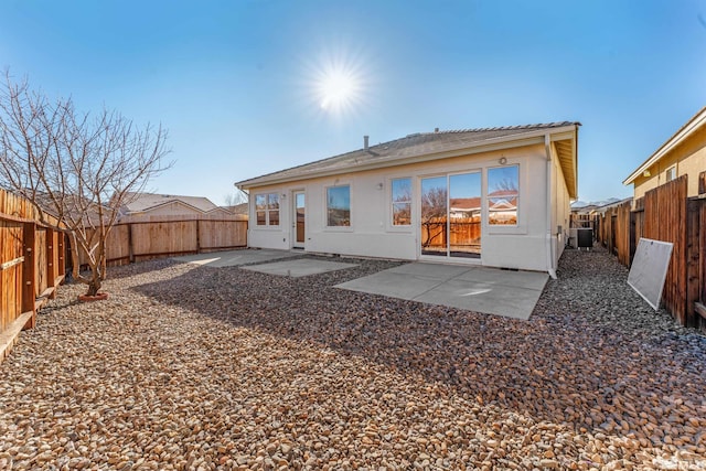 back of property featuring central air condition unit and a patio area