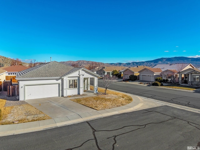 exterior space with a garage and a mountain view