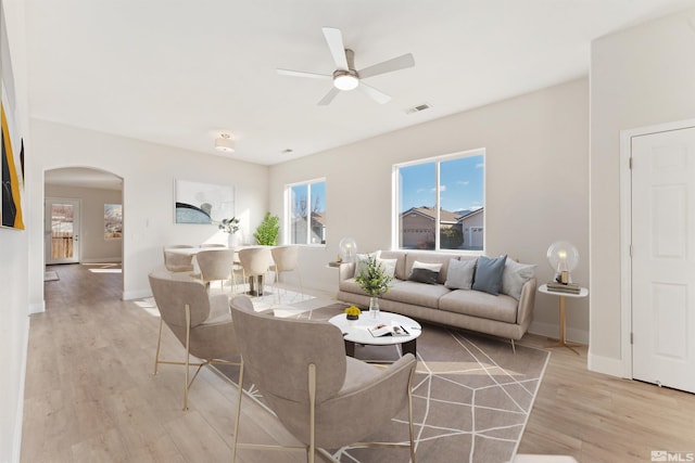 living room featuring ceiling fan and light wood-type flooring