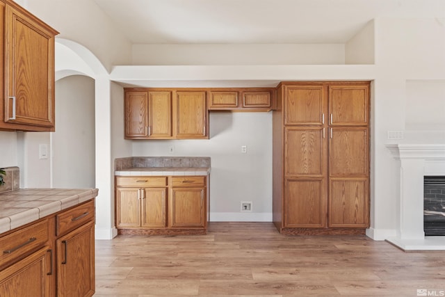 kitchen featuring tile counters and light wood-type flooring