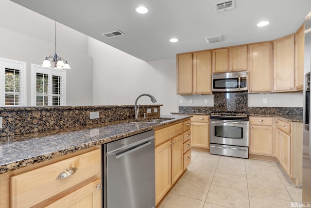 kitchen with sink, light brown cabinets, a chandelier, and appliances with stainless steel finishes