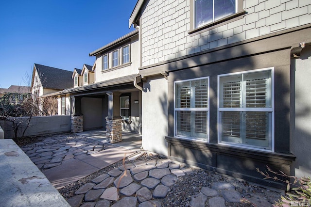 back of property with a patio