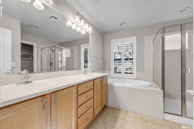 bathroom featuring vanity, tile patterned flooring, and plus walk in shower