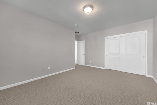 unfurnished bedroom featuring a closet and carpet floors