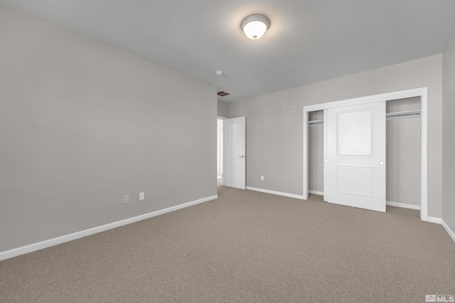 unfurnished bedroom with a closet and carpet floors